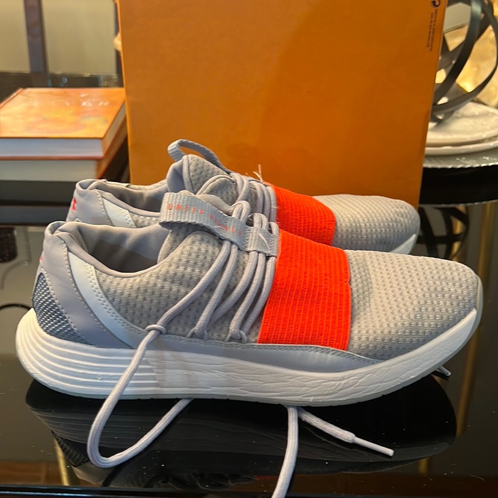 Under Armour grey and pink shoes.